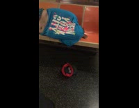 Guy in blue New York City shirt sleeps on subway train with shirt over his head