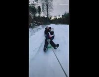 Car pulls friends on sleds through snow