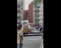 Truck carry a giant shoe along the street 