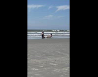 Woman in green bikini lie down sideways at the beach