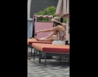 Girl use feet to hold phone bikini