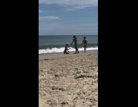 Girl purple bikini kneel sand beach hat