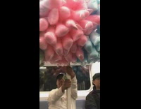 Man on subway with stick pole full of cotton candy