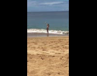 Girl in ocean with drink and phone 