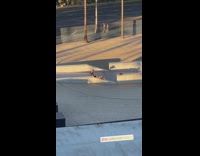 Woman in dress lay down on slant wall barrier