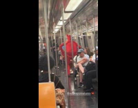 Man wearing crab costume on subway train