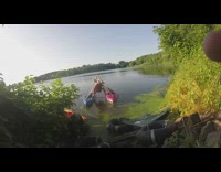 Man ties two kayaks together with a hammock and frame, rows boat and sinks into water