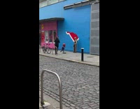 Woman pose beside red mark on blue wall
