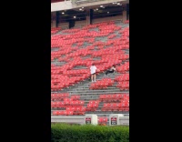 Collab IITW - Woman white top dances at stadium bleachers