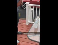 Guy slices four full water bottles knife