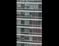 Mannequin seen through skyscraper window