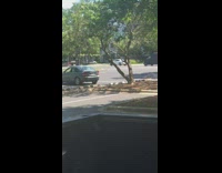 Man black tank top red short pull car empty parking lot