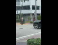 Woman brown shorts poses on the crosswalk