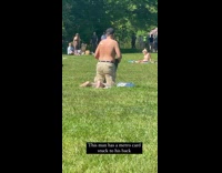 Shirtless Middle Aged Man Has Card Stuck to His Back 
