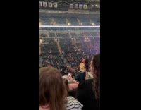 Woman tank top poses at concert balcony