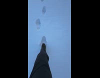 Man tracing footsteps on snow 