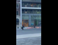 Woman sit crossed leg on street barricade