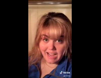 Guy helps girl smell tall flower romantic 