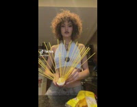 Lady Cooks Pasta Noodles on Bristle Brush