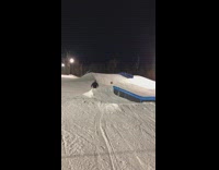Skier grinds a pipe, slips and falls off