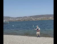 Dad wears baby carrier selfie by water