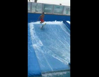 Guy does kickbaord flip and rides on it with knees