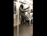 Guy wearing black ski mask dances subway 