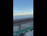 Guy ignores warning sits edge of rock 