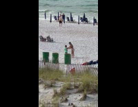 Woman in bikini teaches kid how to take her picture