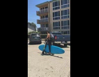 Collab Kook Of The Day - guy on electric scooter carrying blue surf board