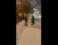 Lady uses ski poles to walk snow 