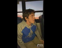 Guy in grey and blue adidas hoodie on bus pretending to be girl