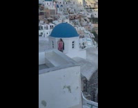 Woman yellow dress and woman pink dress santorini