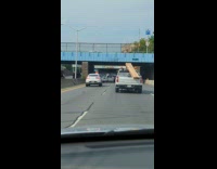Collab WINY - Planks of wood tied at back of truck