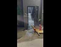 Water floods down stairs out door