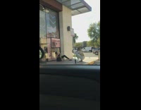 girl sits floor storefront parking