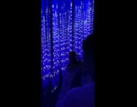Girl walking through LED light strings