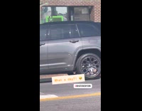 Man playing unplugged electric guitar on sidewalk