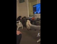 Guy in white plastic  chair falls over and says he is chilling