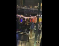 crowd of people in circle singing in street