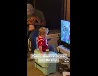 Little boy red jersey drinking from Miller Lite can