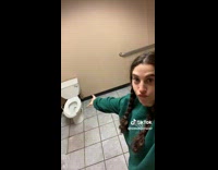 Girl in bathroom with two toilets 