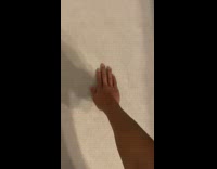 Man stretches and spins his arm on the ground