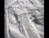 Woman skiing down hill flies forward landing on face