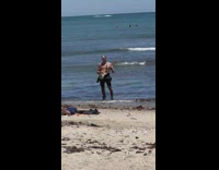 Man plays with electric guitar at the beach