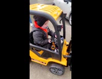 Little boy driving toy forklift 