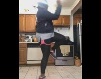 Girl dances kitchen falls fail black dog 