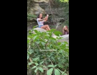 Two girls selfie waterfall white shirt rocks  