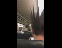 a guy with spiky red blonde hair sitting on train
