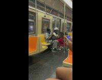 Man in white bucket hat plays music inside the train